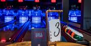 Menu on table with bowling lanes in background