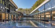 View of length of pool and hot tub