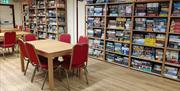 Tables and chairs with shelves full of board games