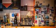 Order area with coffee machine and photographs in background