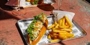 Brioche roll meal with chips and drink