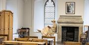 'Jane Austen' sitting in the window of her former schoolroom