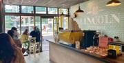 Lincoln Coffee house interior with customers sitting at tables