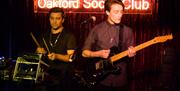 guitarist and drummer playing a concert