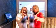 Clayshot - women pointing game rifles at camera