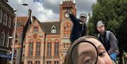 Girl with a magnifying glass in front of Reading Town Hall