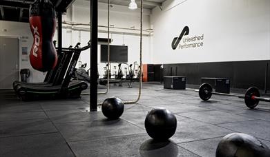 Gym equipment - weights, ropes and a punching bag