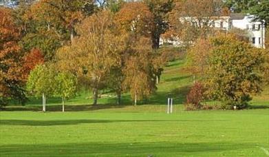 Sports fields with mansion house in background