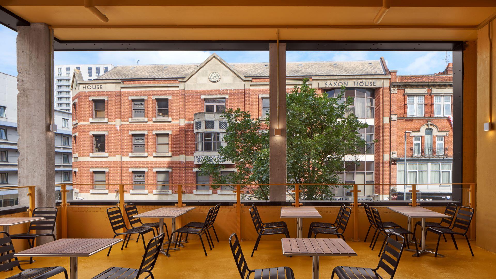 Tables and chairs overlooking window at Reading's Biscuit Factory
