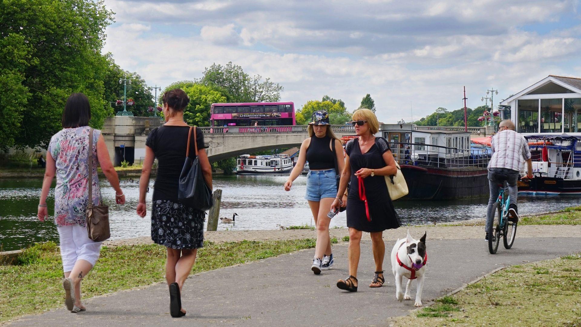 People walking along the Thames Path