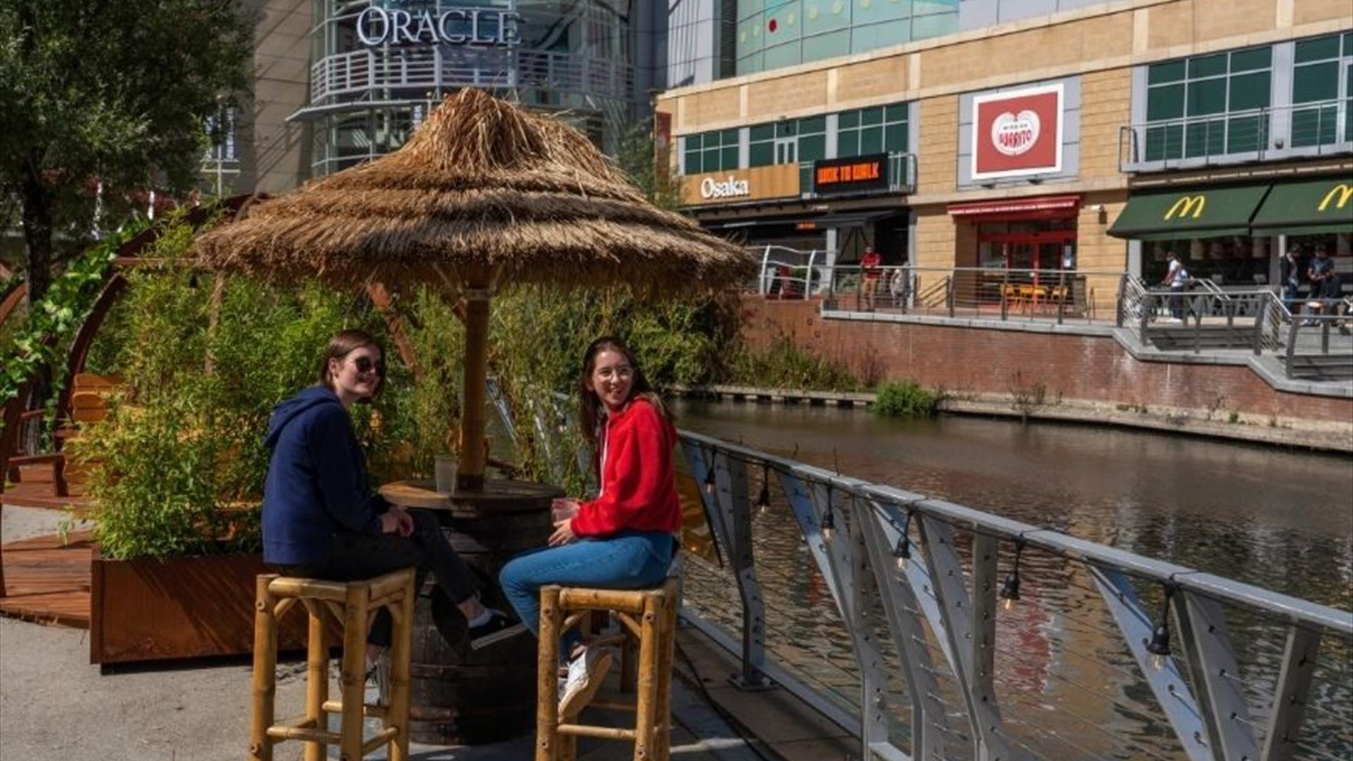 Two girls sitting at The Oracle Riverside Bar