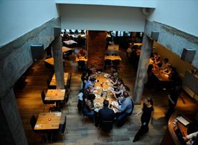 Group of people eating at a table inside Zero Degrees Restaurant in Reading