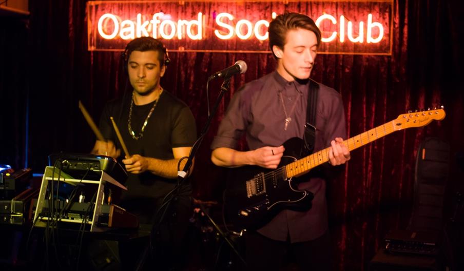 guitarist and drummer playing a concert