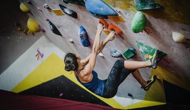 woman climbing indoors climbing wall