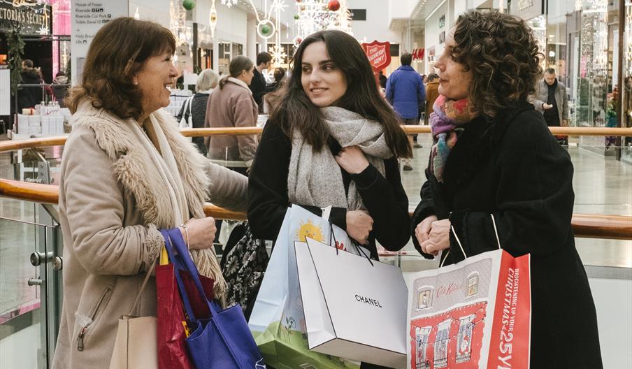 3 women Christmas shopping inside the Oracle shopping centre
