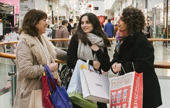 3 women Christmas shopping inside the Oracle shopping centre