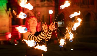 Performer with lit torches.