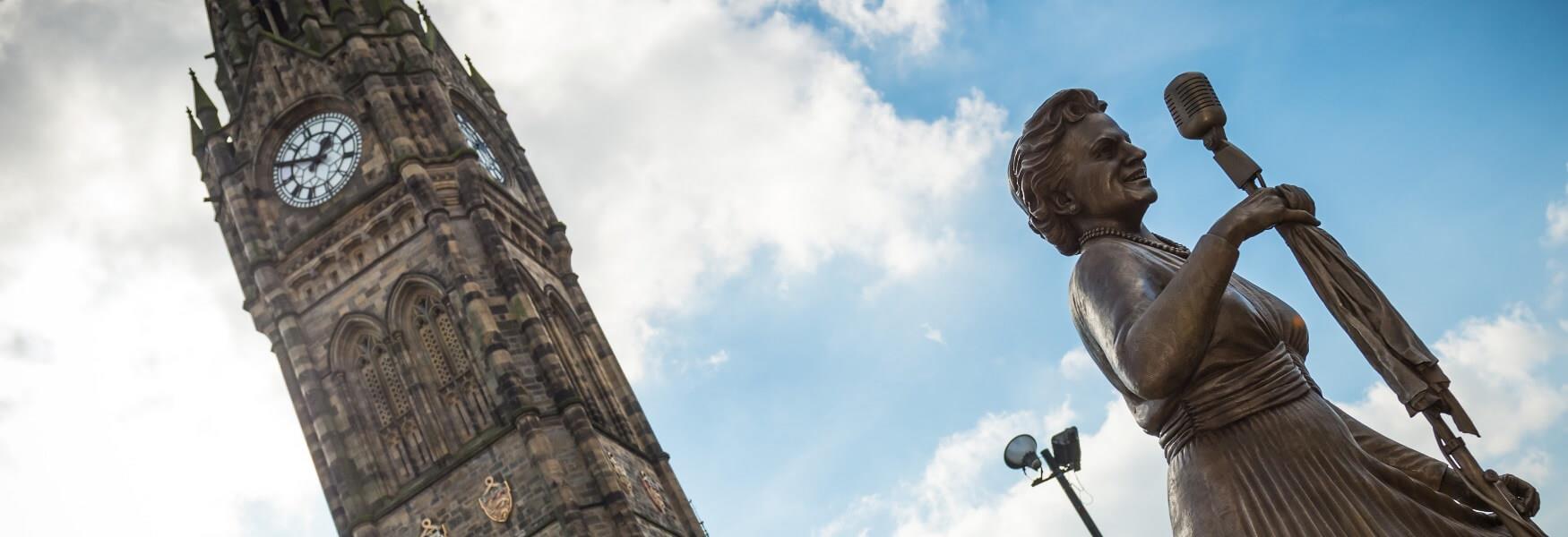 The Gracie Fields statue with the Town Hall clock tower behind.