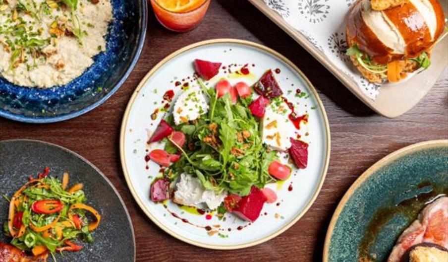 A selection of colourful plates of food.