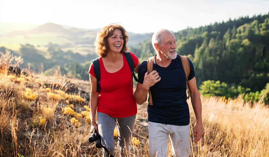 Couple walking across a field.