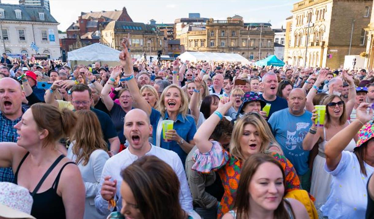 A crowd of people at an outdoor event.