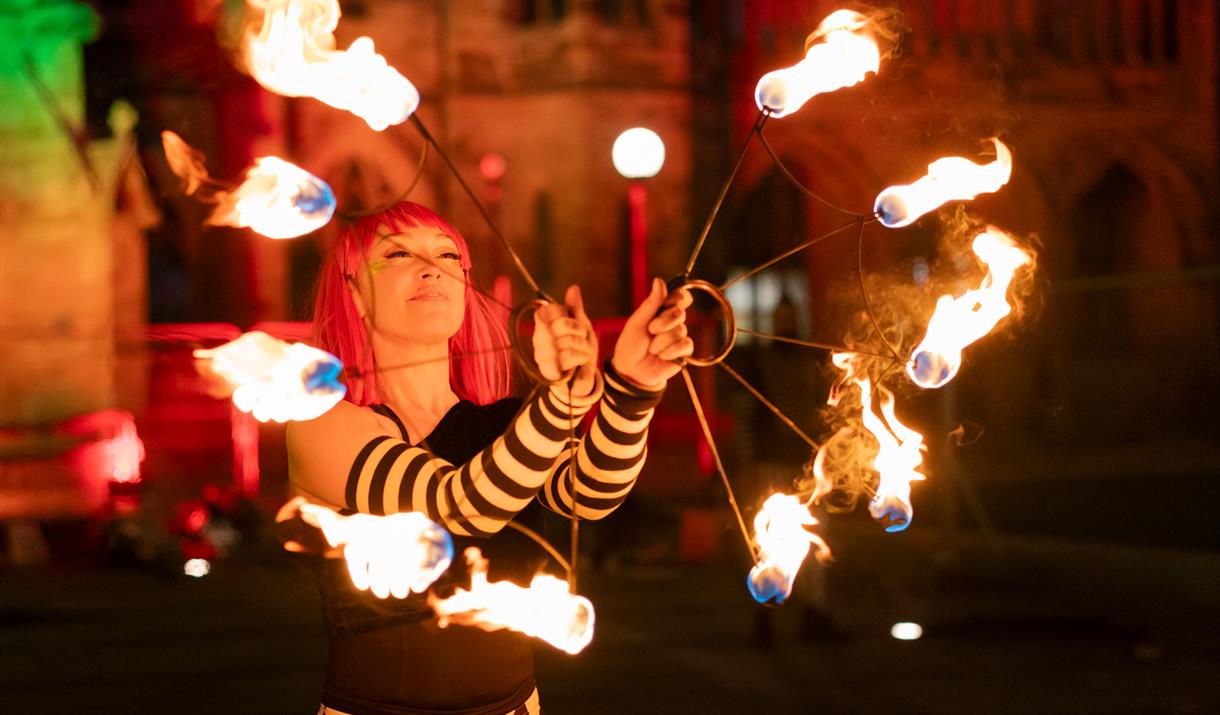 Performer with lit torches.
