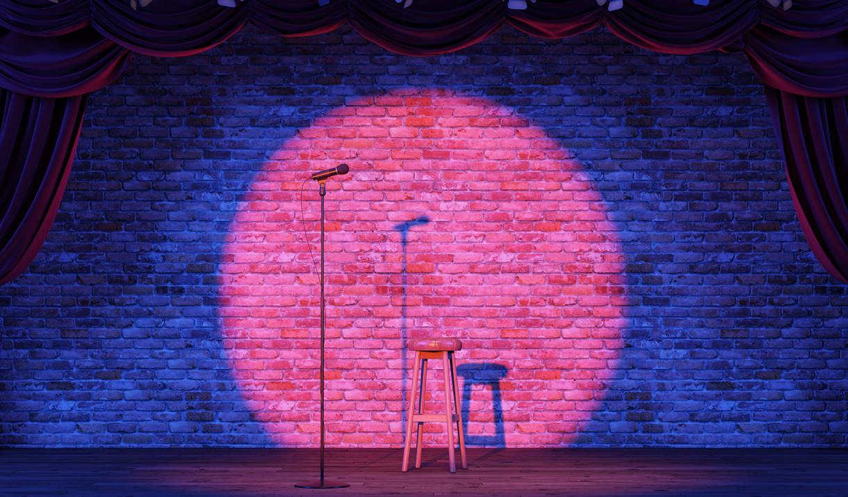 Empty stage with a spotlit microphone.