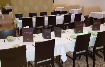 Tables and chairs laid out in the Venus Lounge main dining area.