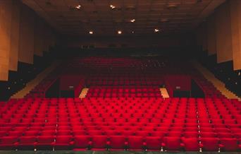 Empty red seats in a theatre