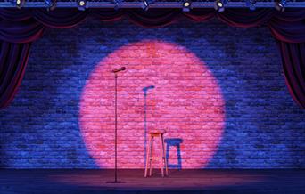 Empty stage with a spotlit microphone.