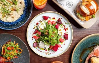 A selection of colourful plates of food.