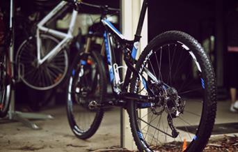 Mountain bikes parked in a garage.