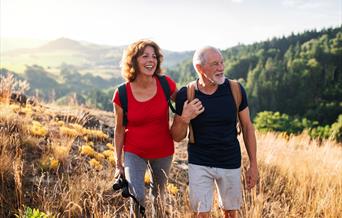 Couple walking across a field.