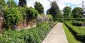 A neatly kept path and flower bed at Denehurst Park.