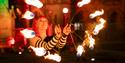 Performer with lit torches.
