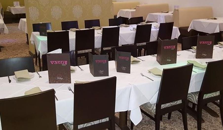 Tables and chairs laid out in the Venus Lounge main dining area.
