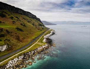 Causeway Coastal Route from above showing the coast road running alongside the sea