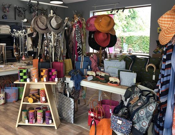 Shop with displays of hats, scarves, jewellery, handbags and more