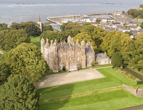 Aerial view of Glenarm Castle & Gardens with the ocean beyond.