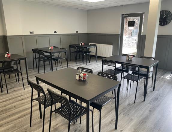 Interior of 7 Bistro / Cafe with grey floor and black tables and chairs