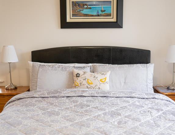 King Bed with garden and sea views.