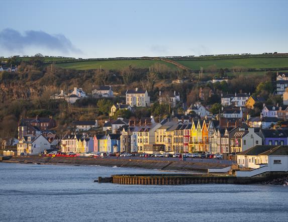 Whitehead promenade with coloured houses and old outdoor swimming pool