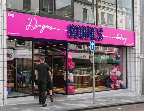 Exterior of Dougies Goodies Bakery in Ballymena with pink and purple signage