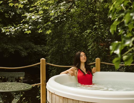 Galgorm Riverside Cottage with outdoor hot tub overlooking the river