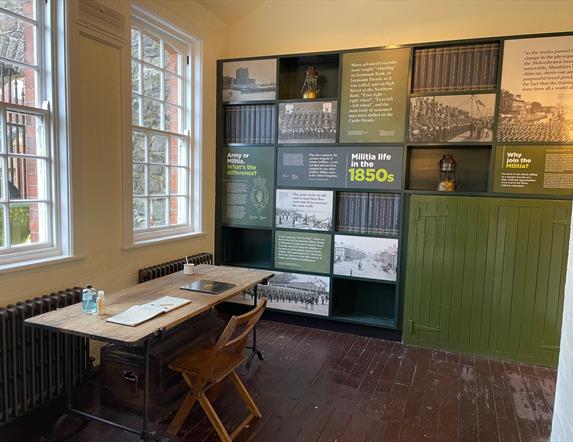 Interior of the Guard Room with information panels on wall and desk with Visitor Book