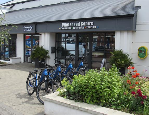Photograph of Whitehead Centre with e-bikes display in a row.