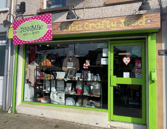 Green shop front of Jenni Mac Gifts & Crafts with window display of crafted items