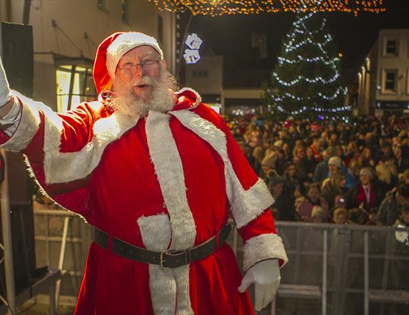 Santa turning on the Christmas Lights