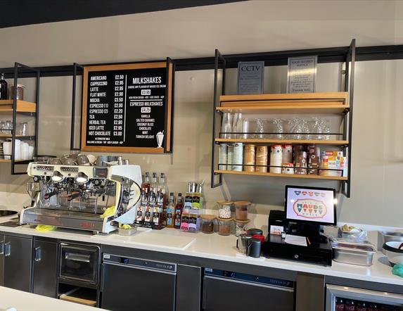 Serving counter at Mauds with hot drinks menus, coffee machines and ice cream containers