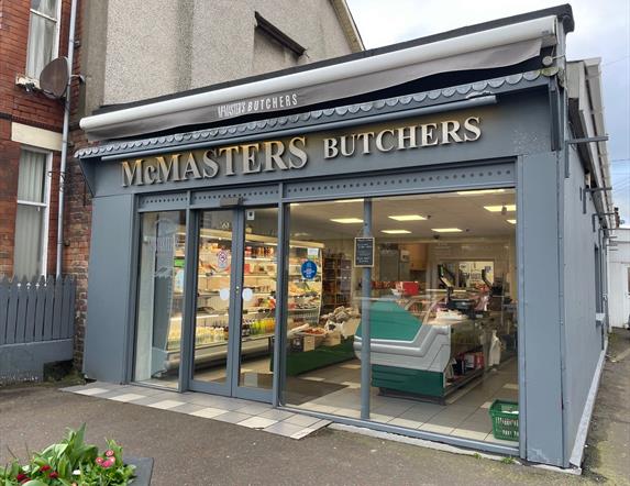 Grey shop frontage of McMasters Butchers in Whitehead